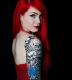 red hair girl tattoo skulls and blue roses