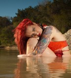 red hair tattoo girl in water