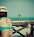 beach girl tattoo stars spine tattoo