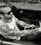 black and white photo guy in car full sleeve tattoo