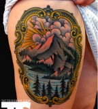 grand mountain tattoo on thigh