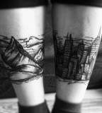 leg tattoo mountains and city