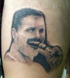 A very blurry Freddie Mercury tattoo