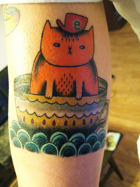 Awesome cat and cup tattoo