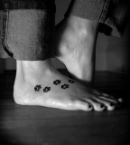 Paw print tatoo on foot