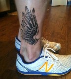 Wings tattoo on leg