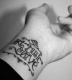 typographic wrist tattoo art music and love