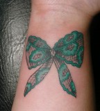 Green bow lace tattoo