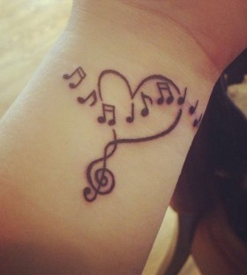 Wrist heart and music tattoo