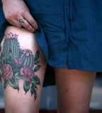 alice carrier tattoo cactus on leg