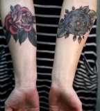 alice carrier tattoo red and blue flowers on inside arms