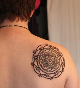 black ink mandala tattoo on back shoulder