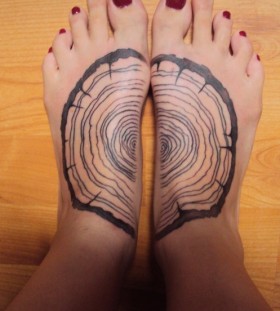 black ink wood tattoo on feet