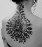 Black flowers back tattoo