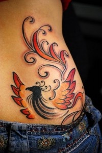 Colorful bird hip tattoo