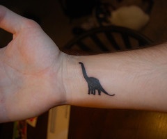 Black small dinosaur tattoo