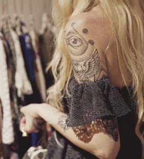 Blond girl eye tattoo