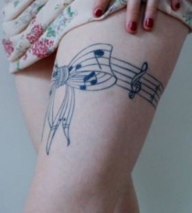 Bow and music legs tattoo
