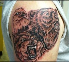 Adorable brown bear tattoo on shoulder