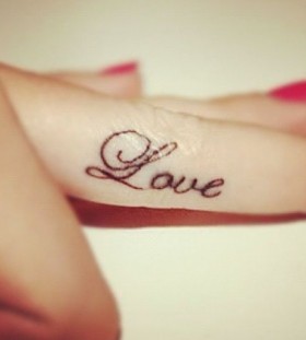 Amazing red nails and love tattoo on arm