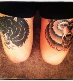 Angry black cat and brown bear tattoo on leg