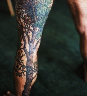 Awesome black tree tattoo on leg