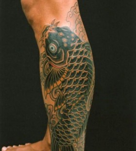Black cute fish tattoo on leg