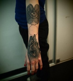 Black owl and amazing wolf tattoo on arm