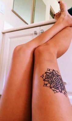 Black simple flower tattoo on leg