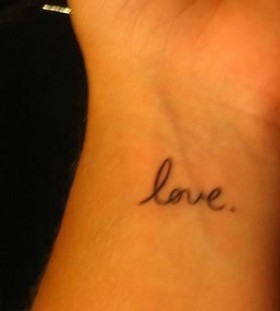 Black simple love tattoo on arm
