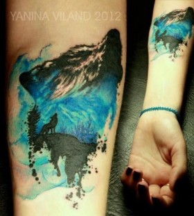 Blue and black wolf tattoo on arm