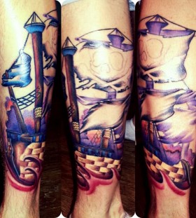 Blue and red ship tattoo on leg