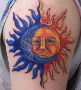Blue and yellow moon tattoo on arm