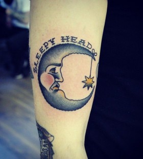Blue and yellow simple moon tattoo on arm