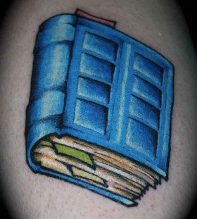 Blue cool book tattoo on arm