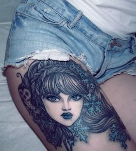Blue women face tattoo on leg