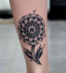 Bright black flower tattoo on leg