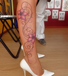 Colorful flower tattoo on leg