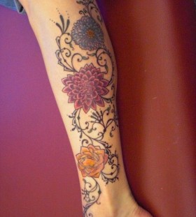Colorful lovely flower tattoo on leg