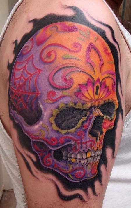 Colorful men’s skull tattoo on shoulder