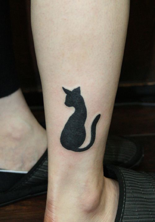 Cool black cat tattoo on leg