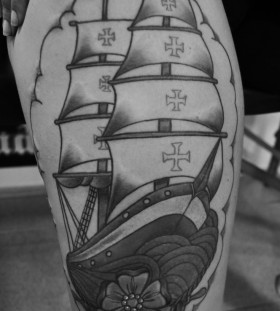Cool black ship tattoo on leg