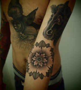 FLower and black horse tattoo on arm