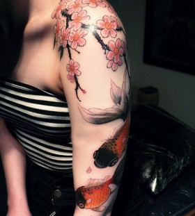 Fish and blossom tree cherry tattoo on arm