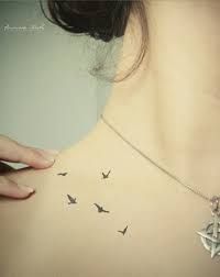 Girl neck bird tattoo