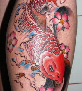 Gorgeous red fish tattoo on leg