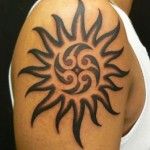 Lovely black sun tattoo on shoulder