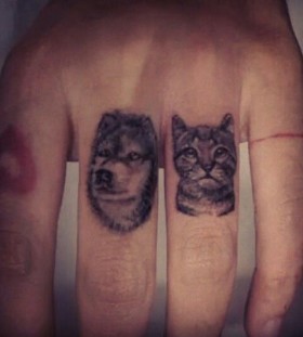Lovely dog and cat tattoo on finger