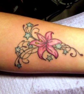 Pink flower and star tattoo on arm