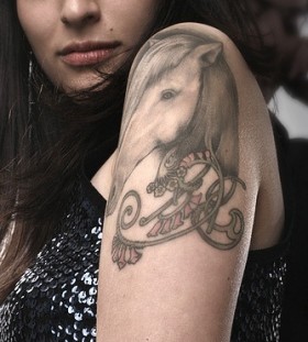 Pretty girl's horse tattoo on arm